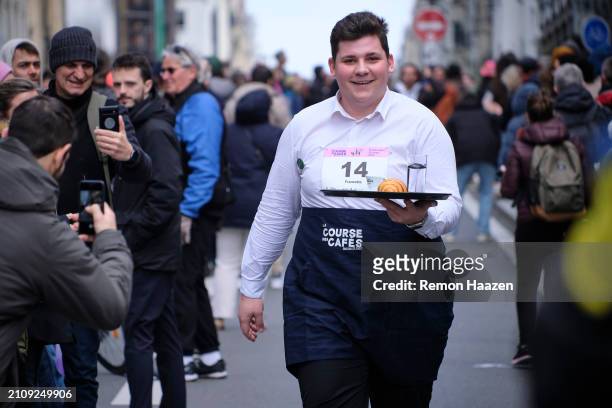Waiter is seen fast walking with a tray during the Cafe run on March 24, 2024 in Paris, France. Three hundred waiters were expected to participate in...