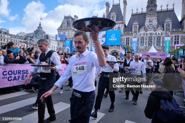 Waiters and waitresses start their fast walk of 2 kilometers with a tray during the Cafe run on March 24, 2024 in Paris, France. Three hundred...