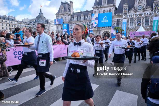 Waiters and waitresses start their fast walk of 2 kilometers with a tray during the Cafe run on March 24, 2024 in Paris, France. Three hundred...