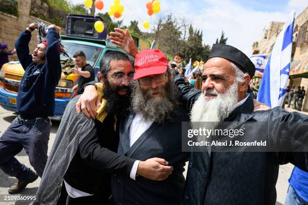 Jewish settlers wearing costumes celebrate Purim as Israeli security forces secure the celebrations on March 24, 2024 in Hebron, West Bank. Unlike...