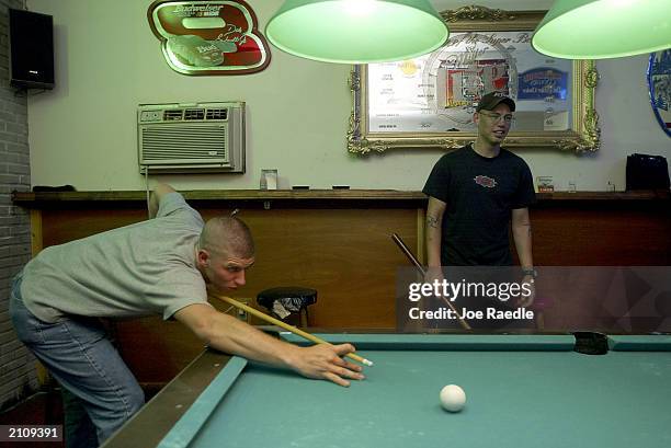 Marine Lance Corporal David Mattson and Lance Corporal Billie Pickering from 1/2 Charlie Company of Task Force Tarawa play pool June 24, 2003 in a...