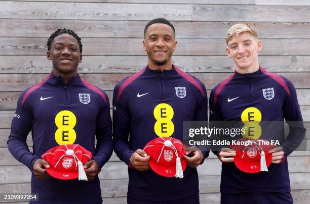 Kobbie Mainoo, Ezri Konsa and Anthony Gordon of England pose for a photo with their England Legacy Caps at Tottenham Hotspur Training Centre on March...