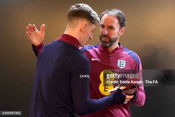 Gareth Southgate, Manager of England men's senior team, presents Anthony Gordon of England with their England Legacy Cap at Tottenham Hotspur...