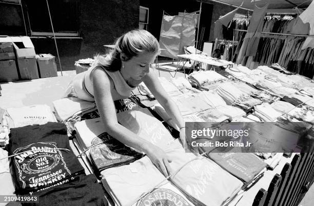 Shirt Vendor Kathy Jacobs from Venice prepares her shirts for a day of sales, July 11, 1983 in Venice Beach section of Los Angeles, California.