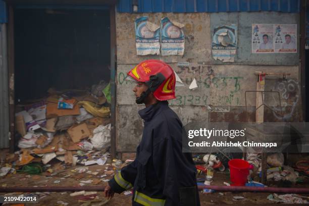 Firefighter arrives at the scene of a fire which engulfed a slum dwelling on March 24, 2024 in the Banani neighbourhood of Dhaka, Bangladesh.