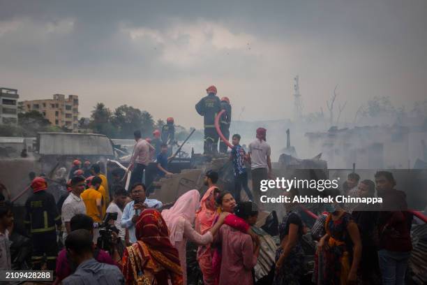 Firefighters attempt to douse a fire which engulfed a slum dwelling on March 24, 2024 in the Banani neighbourhood of Dhaka, Bangladesh.