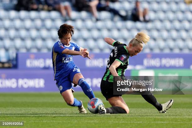 Yuka Momiki of Leicester City and Guro Bergsvand of Brighton & Hove Albion battle for possession during the Barclays Women's Super League match...