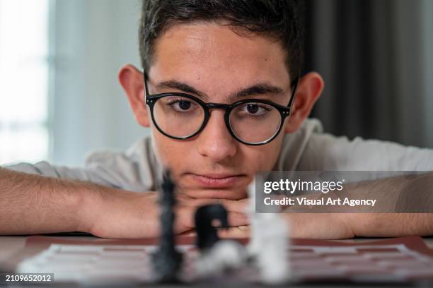 chess board is oreground boy is background focus on background horizontal still - choosing between two things stock pictures, royalty-free photos & images