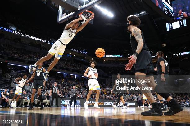 Oso Ighodaro of the Marquette Golden Eagles dunks the ball against the Colorado Buffaloes during the first half in the second round of the NCAA Men's...