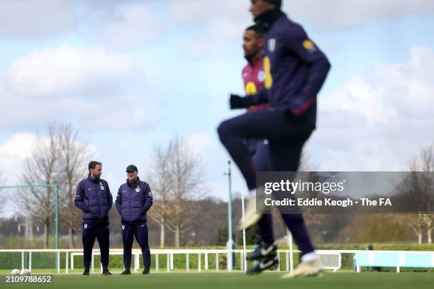 Gareth Southgate, Manager of England men's senior team, and Steve Holland, Assistant Manager of England, look on during a training session at...