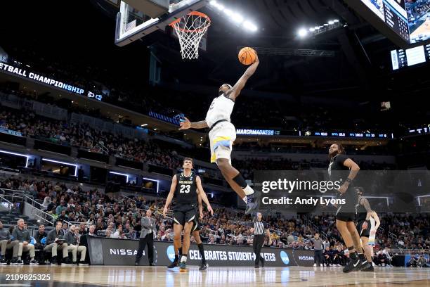Chase Ross of the Marquette Golden Eagles dunks the ball against the Colorado Buffaloes during the first half in the second round of the NCAA Men's...