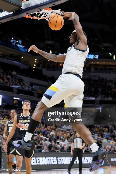 Chase Ross of the Marquette Golden Eagles dunks the ball against the Colorado Buffaloes during the first half in the second round of the NCAA Men's...