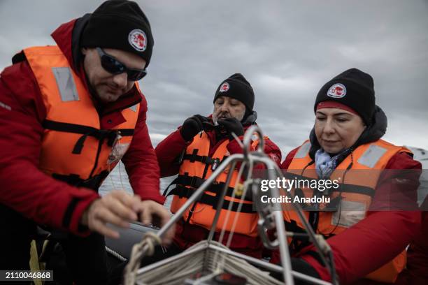 Turkish professors Nuket Sivri , Ertugrul Agirbas and expedtiion leader professor Ersan Basar collect samples from the oceans and lakes around...