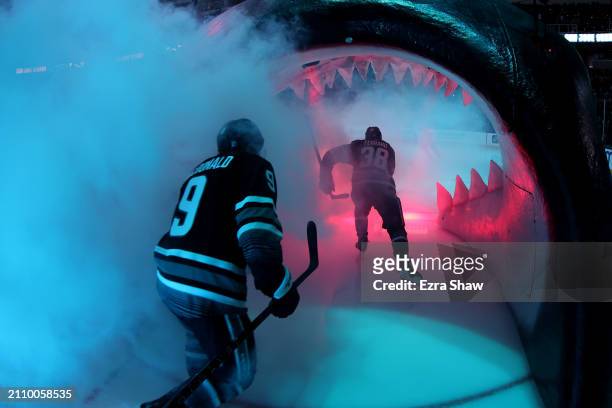 Jacob MacDonald and Mario Ferraro of the San Jose Sharks skate onto the ice for their game against the Chicago Blackhawks at SAP Center on March 23,...