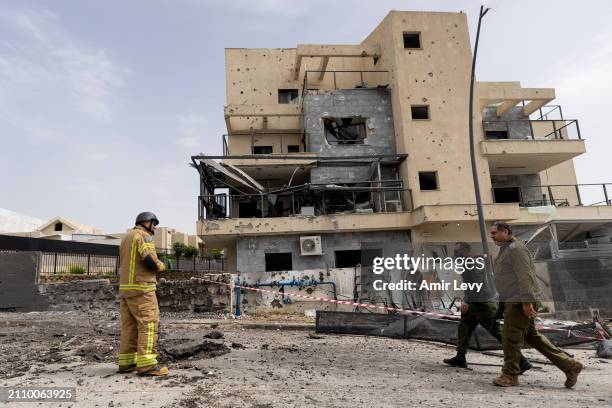 Israeli emergency responders inspect a building that was damaged from a rocket fired from Lebanon on March 27, 2024 in Kiryat Shmona, Israel. One man...