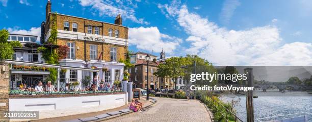 people enjoying pub overlooking summer river panorama richmond thames london - richmond upon thames stock pictures, royalty-free photos & images