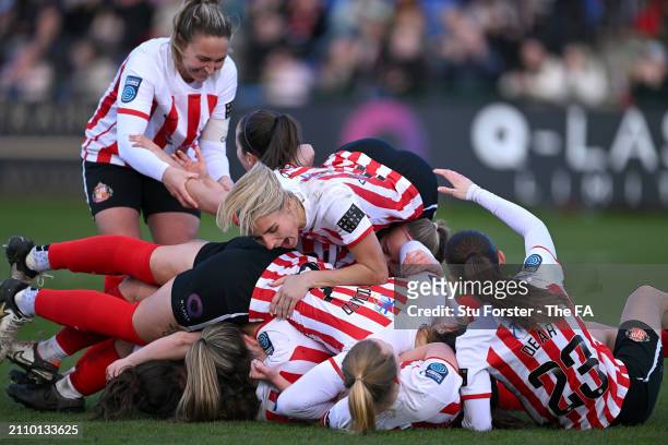 Louise Griffiths piles on to celebrate with teammates after Mary McAteer of Sunderland had scored her team's third goal with teammates during the...
