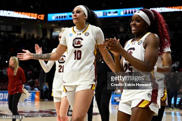 Raven Johnson and Kamilla Cardoso of the South Carolina Gamecocks walk off the court after their win over the North Carolina Tar Heels during the...
