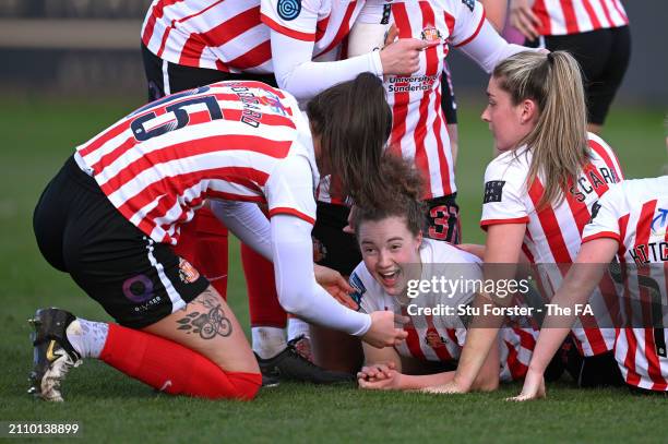 Mary McAteer of Sunderland celebrates with team mates after scoring her team's third goal during the Barclays Women's Championship match between...