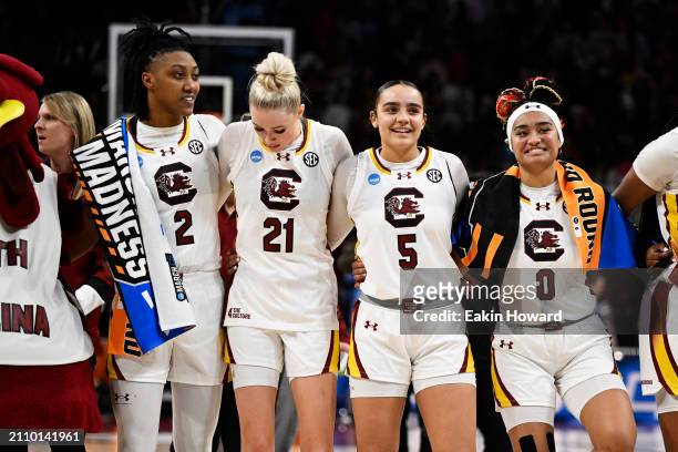 Ashlyn Watkins, Chloe Kitts, Tessa Johnson, and Te-Hina Paopao of the South Carolina Gamecocks stand on the court after their win over the North...
