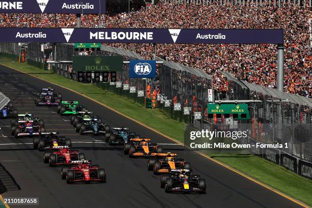 Max Verstappen of the Netherlands driving the Oracle Red Bull Racing RB20 leads Carlos Sainz of Spain driving the Ferrari SF-24 and the rest of the...