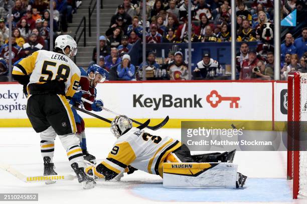 Jonathan Drouin of the Colorado Avalanche scores the winning goal against Kris Letang and goalie Alex Nedeljkovic of the Pittsburgh Penguins during...