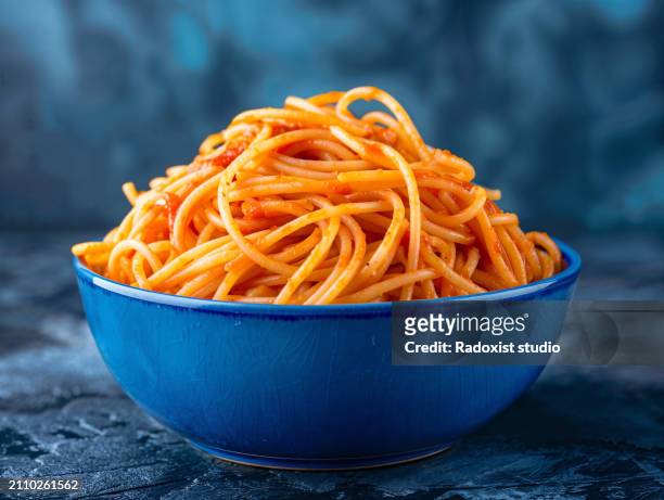spaghetti with tomato sauce  in modern ceramic bowl on dark slate table - clean slate stock pictures, royalty-free photos & images