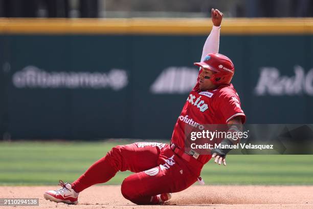 Franklin Barreto of Diablos Rojos slides into second base during Spring Training Game One between Diablos Rojos and New York Yankees at Estadio...