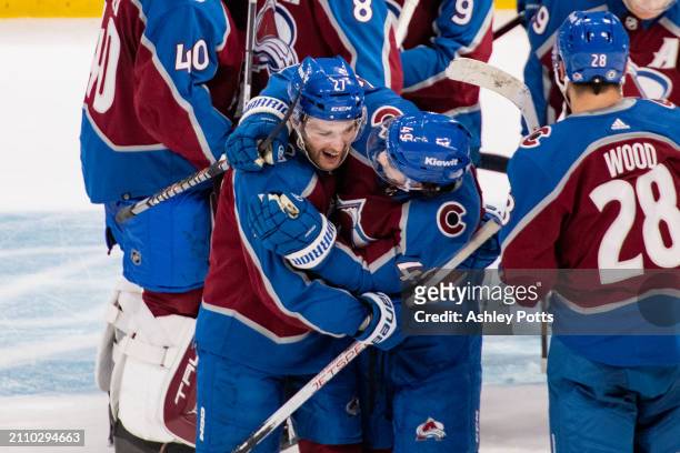 Samuel Girard hugs Jonathan Drouin of the Colorado Avalanche after Drouin scored the game-winning goal in overtime against the Pittsburgh Penguins at...