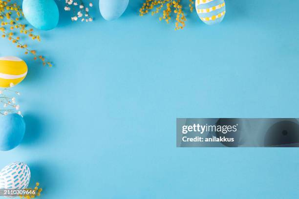 colorful easter eggs on blue background - easter stock pictures, royalty-free photos & images