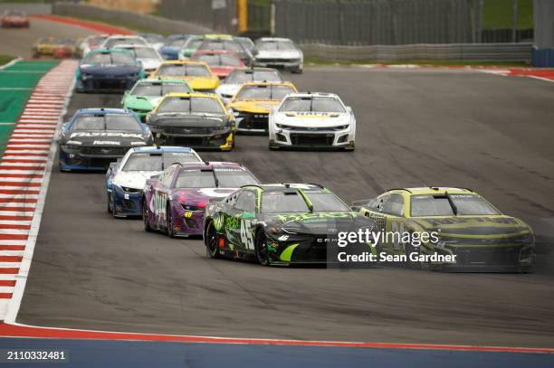 William Byron, driver of the RaptorTough.com Chevrolet, and Tyler Reddick, driver of the The Beast Unleashed Toyota, race during the NASCAR Cup...
