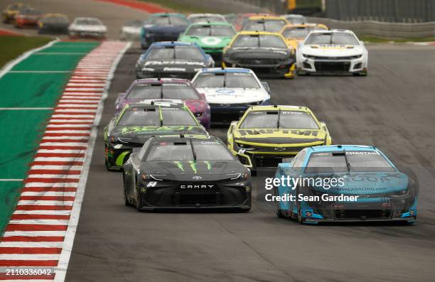 Ross Chastain, driver of the Worldwide Express Chevrolet, and Ty Gibbs, driver of the Monster Energy Toyota, race during the NASCAR Cup Series...