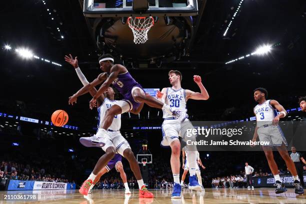 Xavier Brown of the James Madison Dukes passes the ball during the first half of the game against the Duke Blue Devils during the second round of the...