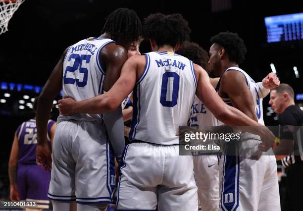 Duke Blue Devils players huddle during the first half against the James Madison Dukes in the second round of the NCAA Men's Basketball Tournament at...