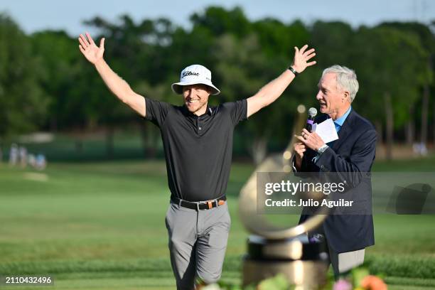 Gary Koch presents Peter Malnati of the United States the Valspar Championship Trophy after the final round of the Valspar Championship at Copperhead...