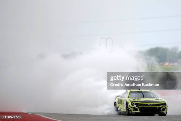 William Byron, driver of the RaptorTough.com Chevrolet, celebrates with a burnout after winning the NASCAR Cup Series EchoPark Automotive Grand Prix...