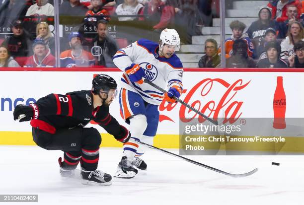 Warren Foegele of the Edmonton Oilers shoots the puck past Artem Zub of the Ottawa Senators during the first period at Canadian Tire Centre on March...