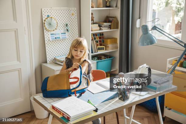 schoolgirl packing for school - school supplies on desk stock pictures, royalty-free photos & images