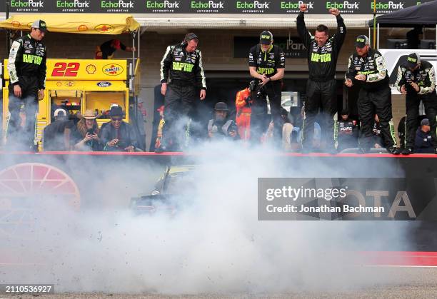 William Byron, driver of the RaptorTough.com Chevrolet, performs a burnout as crew celebrate and Grand Marshal Giancarlo Esposito looks on after...