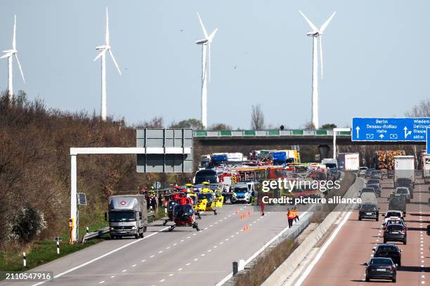 March 2024, Saxony, Schkeuditz: Emergency vehicles and rescue helicopters are at the scene of the accident on the A9. At least one person has died in...