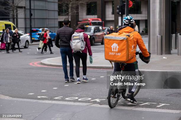 Just Eat takeaway delivery cycle courier on 4th March 2024 in London, United Kingdom. Just Eat acts as an intermediary between independent takeaway...