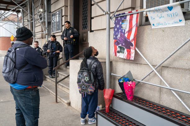 March 26: People pay their respects at a memorial for slain NYPD officer Jonathan Diller outside the 101th Pct. Is pictured Tuesday, March 26, 2024...