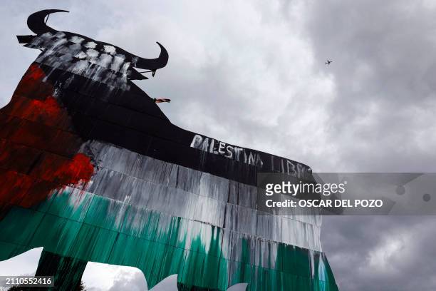 Picture taken on March 27, 2024 shows one of the Spain's famous Osborne Bull billboards painted with the Palestinian flag and a writing reading "Free...
