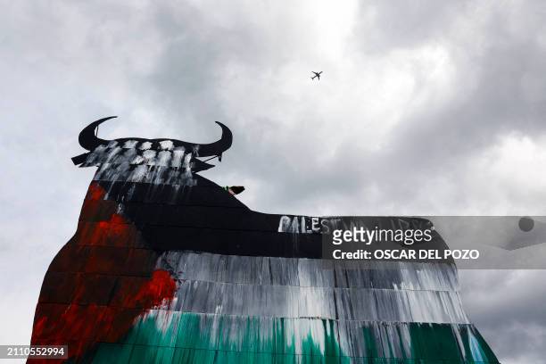 Picture taken on March 27, 2024 shows one of the Spain's famous Osborne Bull billboards painted with the Palestinian flag and a writing reading "Free...