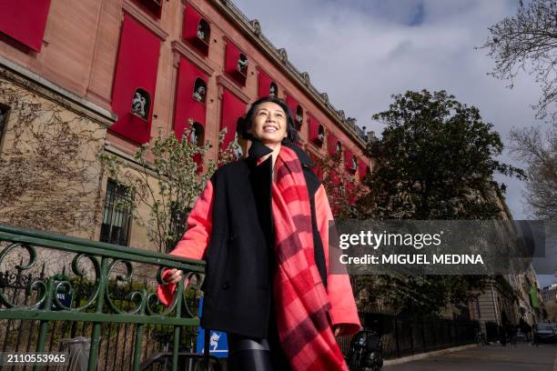 Chinese artist Jiang Qiong Er poses in front of the facade of the Asian arts Guimet Museum she dressed with her installation, in center Paris on...