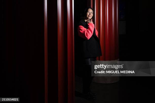 Chinese artist Jiang Qiong Er poses, in center Paris on March 27 inside the Asian arts Guimet Museum whose facade is dressed with her installation....