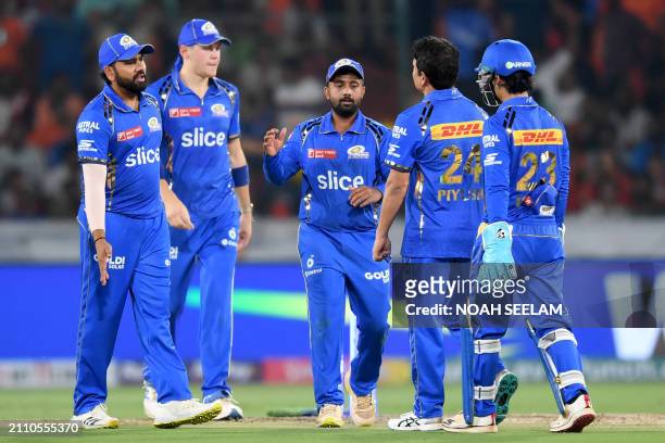 Mumbai Indians' players celebrate after the dismissal of Sunrisers Hyderabad's Abhishek Sharma during the Indian Premier League Twenty20 cricket...