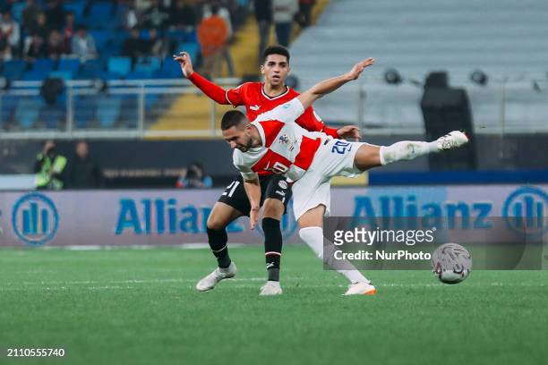 Ahmed Hassan Koka is playing with a Croatian national team player during a friendly football match between Egypt and Croatia at Misr Stadium in the...