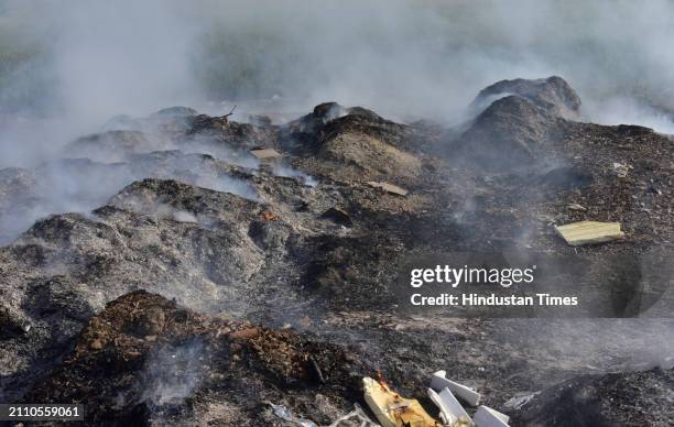 Smoke rising from garbage set on fire in the Ghaziabad Wave City area is polluting the environment on March 27, 2024 in Ghaziabad, India.