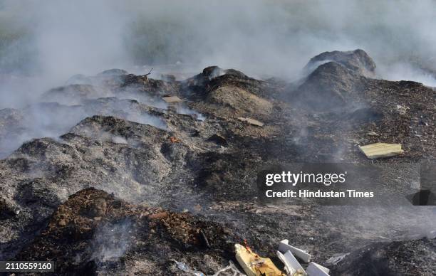 Smoke rising from garbage set on fire in the Ghaziabad Wave City area is polluting the environment on March 27, 2024 in Ghaziabad, India.